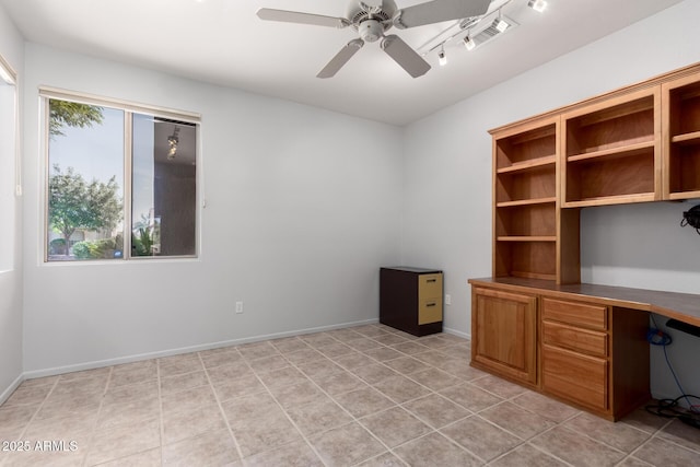 unfurnished office with baseboards, visible vents, ceiling fan, built in desk, and light tile patterned flooring