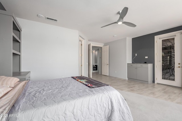 bedroom with visible vents, ceiling fan, and wood finished floors