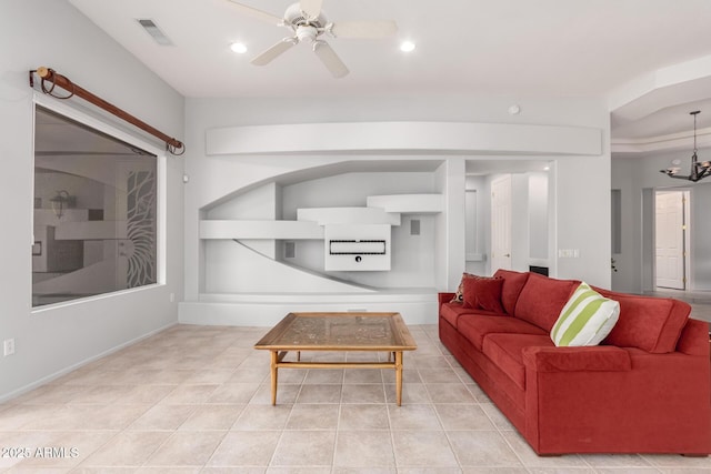 tiled living room with recessed lighting, visible vents, and ceiling fan with notable chandelier