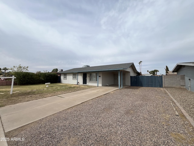 ranch-style house with a gate, fence, a front lawn, and concrete driveway