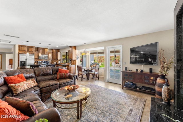 living room featuring light tile patterned floors and visible vents