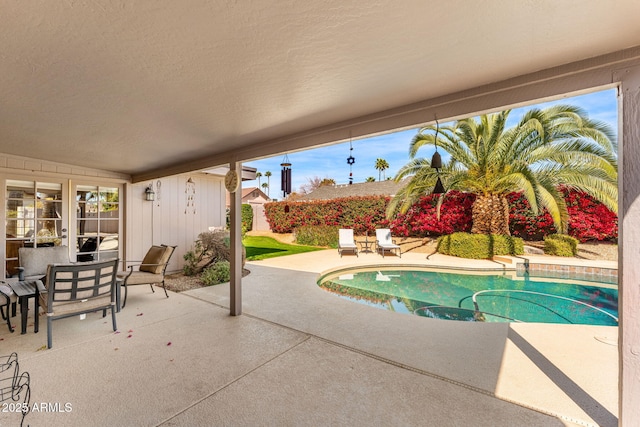 view of swimming pool featuring a fenced in pool and a patio area