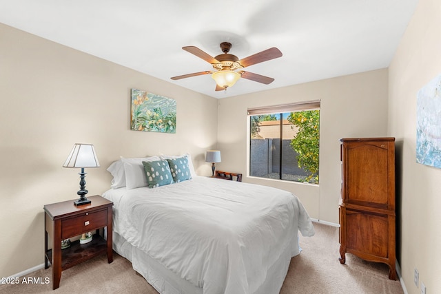 bedroom with a ceiling fan, light colored carpet, and baseboards