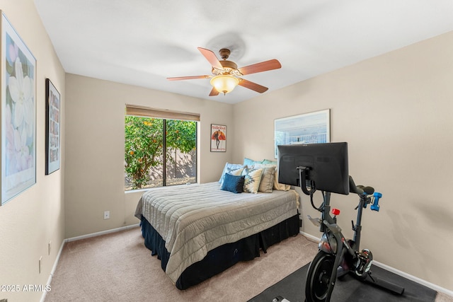 carpeted bedroom with ceiling fan and baseboards