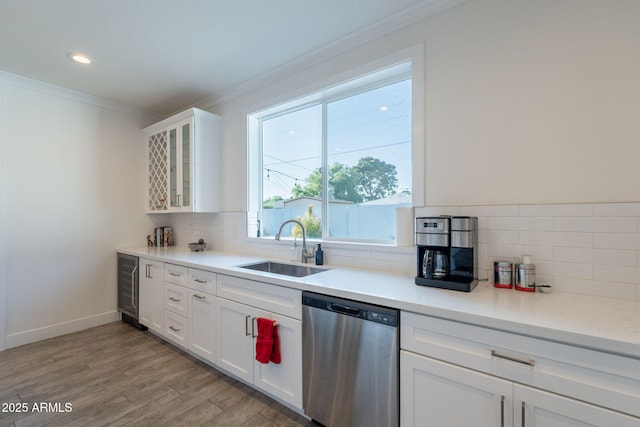 3834 E Clarendon Ave, Phoenix, AZ 85018 - kitchen with dishwasher, a sink, crown molding, beverage cooler, and backsplash