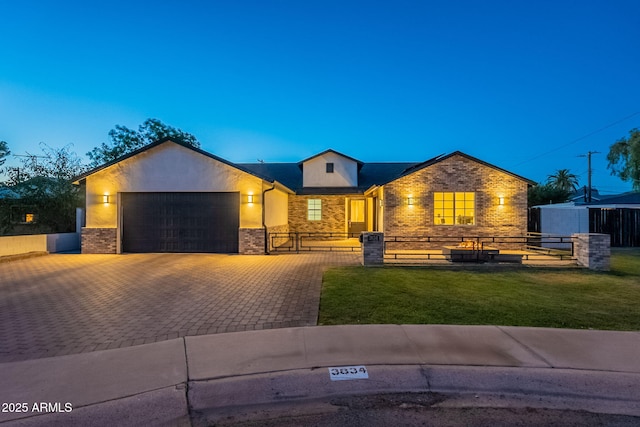 3834 E Clarendon Ave, Phoenix, AZ 85018 - ranch-style house featuring a garage, brick siding, and decorative driveway