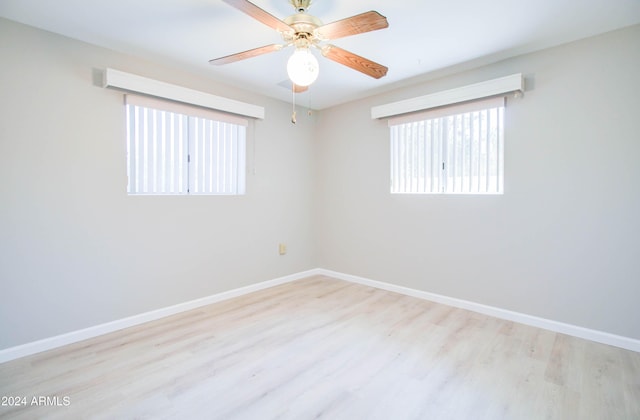 spare room with ceiling fan and light hardwood / wood-style flooring