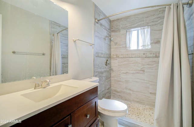 bathroom featuring walk in shower, vanity, and toilet