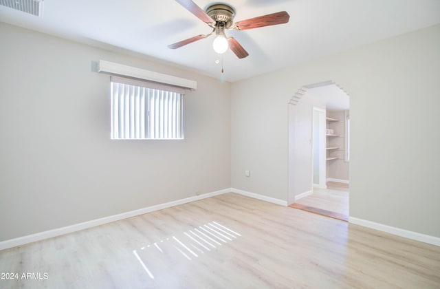 spare room featuring ceiling fan and light hardwood / wood-style flooring