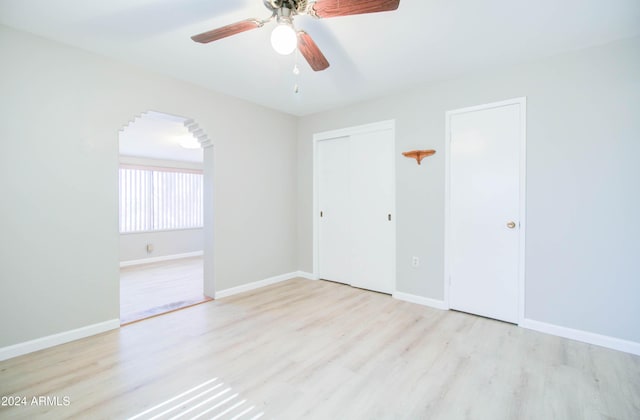 unfurnished bedroom with light wood-type flooring and ceiling fan