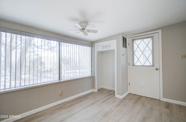 foyer entrance with a wealth of natural light, light hardwood / wood-style flooring, and ceiling fan