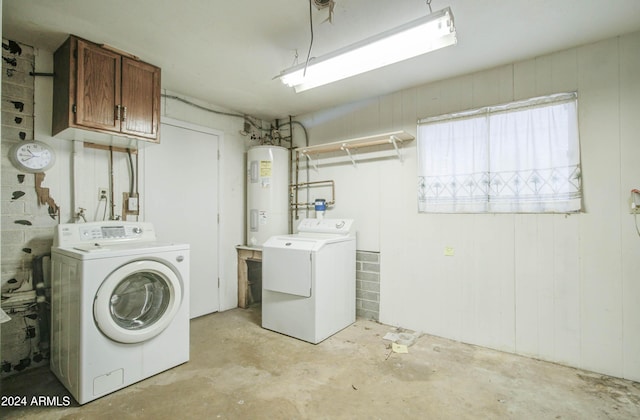 laundry room featuring washer and dryer, cabinets, and electric water heater