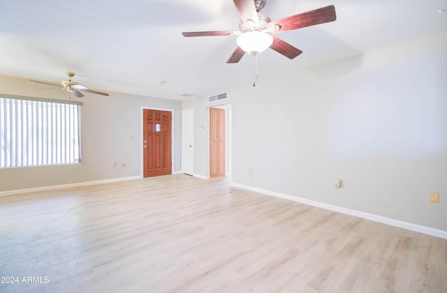 empty room featuring ceiling fan and light hardwood / wood-style floors