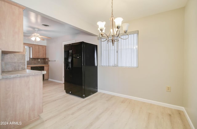 kitchen with ceiling fan with notable chandelier, decorative backsplash, light wood-type flooring, decorative light fixtures, and black fridge with ice dispenser