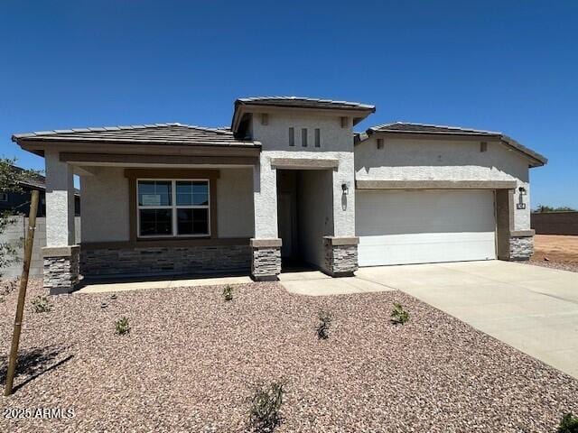 18348 W Gray Fox Trl, Wittmann, AZ 85361 - prairie-style house featuring concrete driveway, stone siding, a garage, and stucco siding