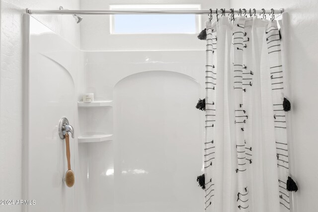 18348 W Gray Fox Trl, Wittmann, AZ 85361 - room details featuring a shower with shower curtain