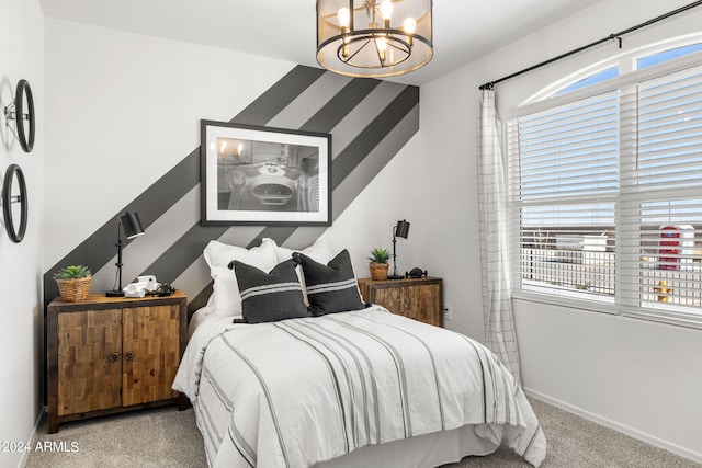 18348 W Gray Fox Trl, Wittmann, AZ 85361 - bedroom with carpet flooring, baseboards, and an inviting chandelier