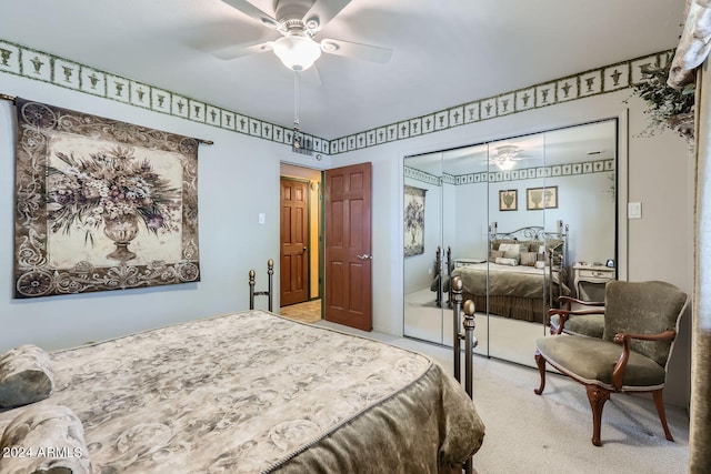 carpeted bedroom with ceiling fan and a closet