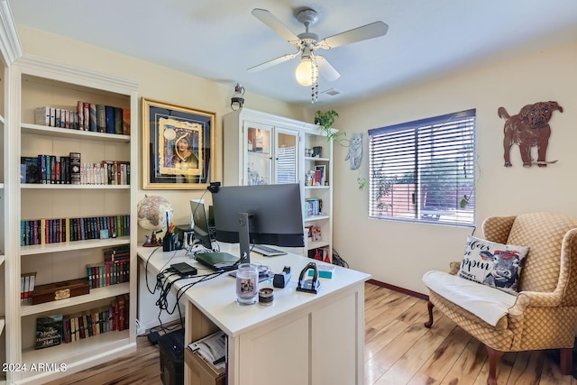 office area with light wood-type flooring and ceiling fan