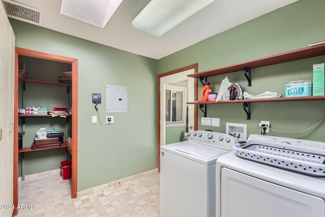 clothes washing area with electric panel and independent washer and dryer