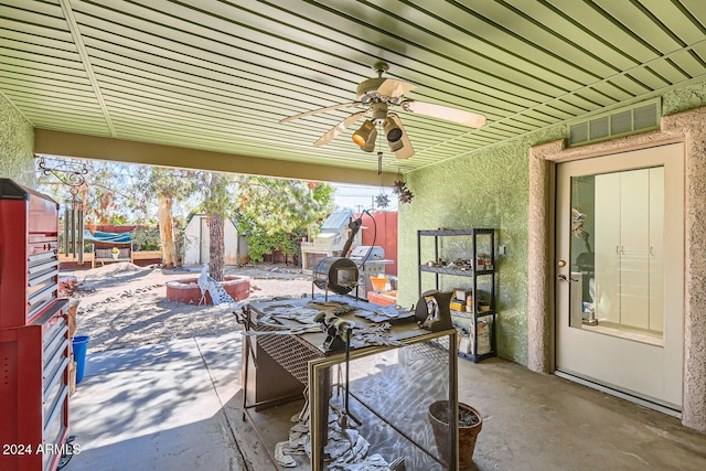 view of patio with a shed and ceiling fan