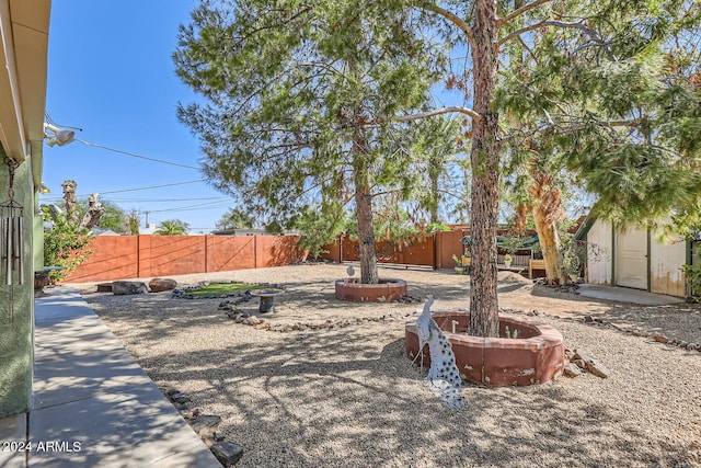 view of yard with an outdoor fire pit