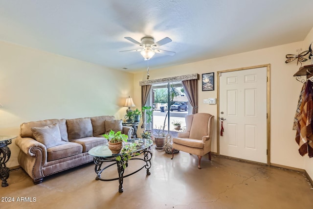 living room with concrete floors, ceiling fan, and a textured ceiling