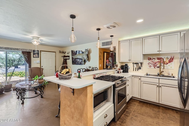 kitchen featuring a kitchen breakfast bar, hanging light fixtures, kitchen peninsula, stainless steel appliances, and sink