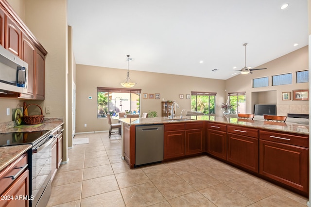 kitchen with ceiling fan, pendant lighting, lofted ceiling, sink, and stainless steel appliances