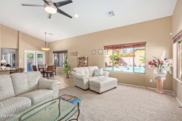 carpeted living room featuring french doors, high vaulted ceiling, and ceiling fan