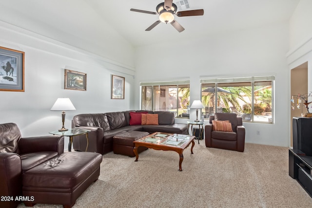 carpeted living room featuring ceiling fan and high vaulted ceiling