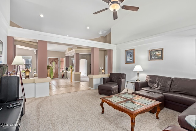 carpeted living room with high vaulted ceiling and ceiling fan