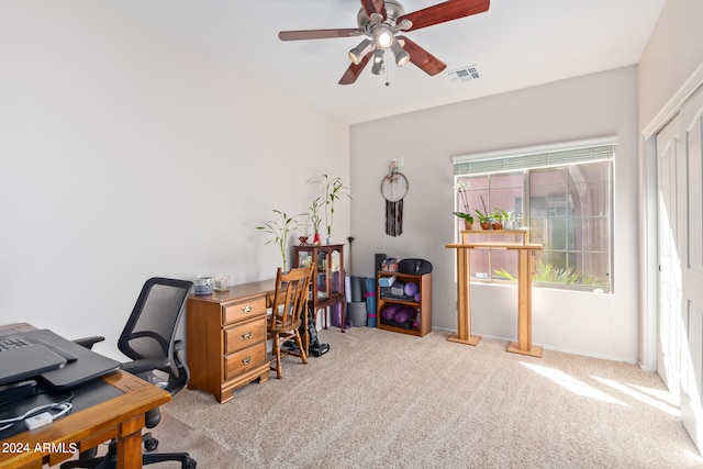 carpeted office with ceiling fan