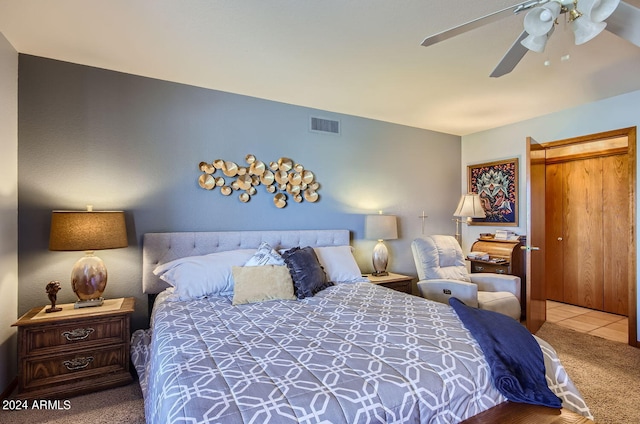 bedroom with carpet floors, visible vents, and a ceiling fan