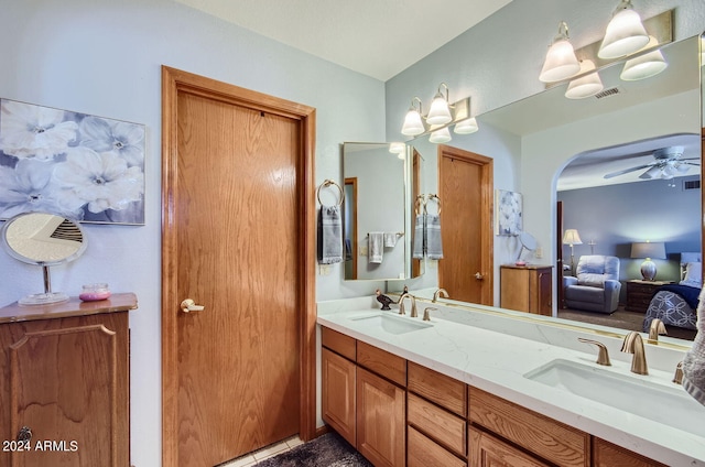 full bath featuring double vanity, ceiling fan, visible vents, and a sink