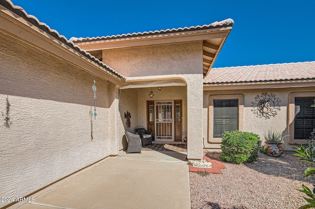 doorway to property with stucco siding