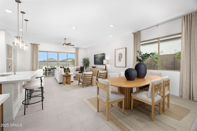 dining area featuring ceiling fan and sink