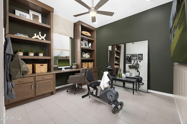 office area with built in desk and ceiling fan