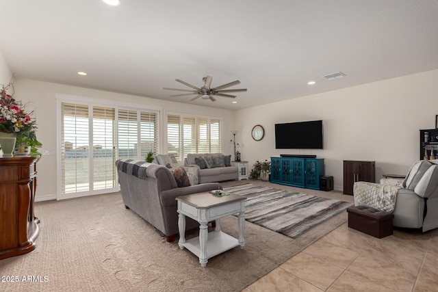 living room featuring ceiling fan, a healthy amount of sunlight, and light tile patterned floors