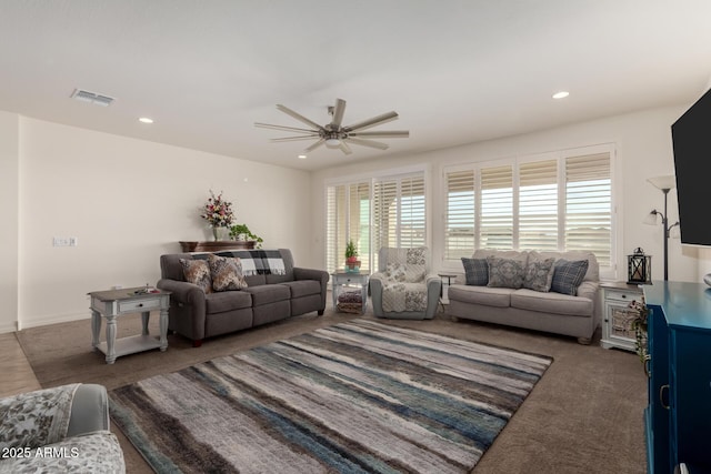 carpeted living room featuring ceiling fan