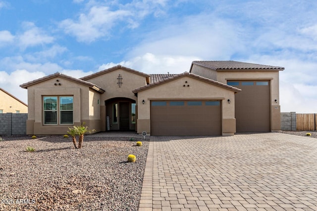 mediterranean / spanish-style house with a garage