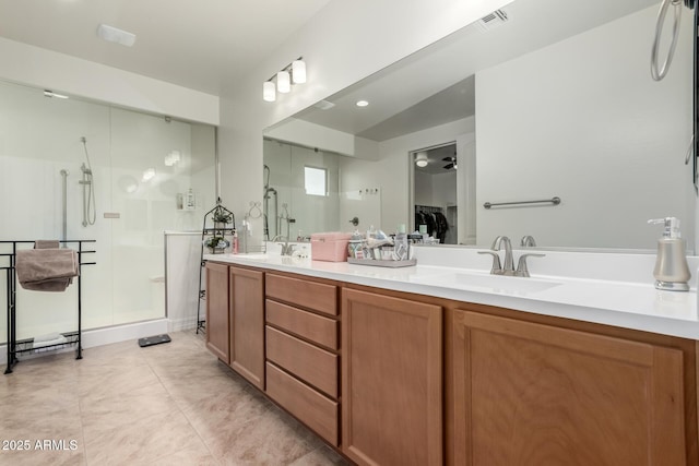 bathroom featuring tile patterned floors, vanity, and a shower with shower door