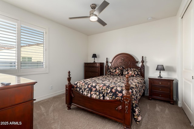 carpeted bedroom with ceiling fan and a closet