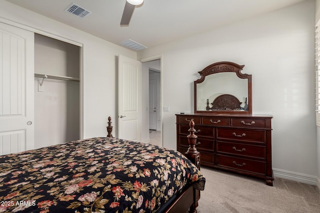 bedroom with ceiling fan, light carpet, and a closet