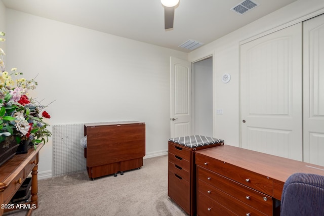 office space with light carpet and ceiling fan