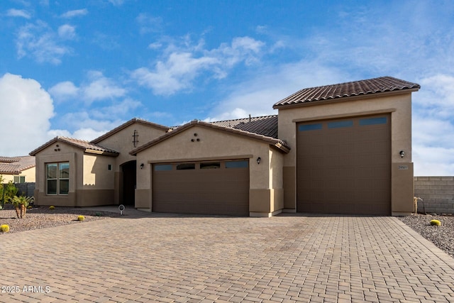 mediterranean / spanish-style home with a garage