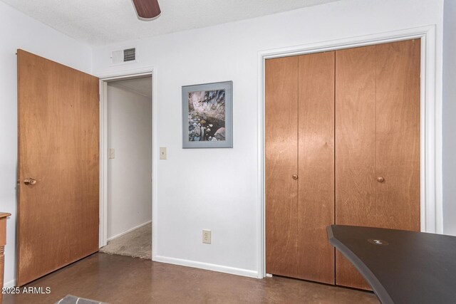 62 W Beall Ave, Mesa, AZ 85210 - unfurnished bedroom featuring a closet, finished concrete floors, and baseboards