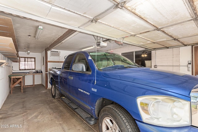 62 W Beall Ave, Mesa, AZ 85210 - garage featuring a garage door opener and a wall mounted air conditioner
