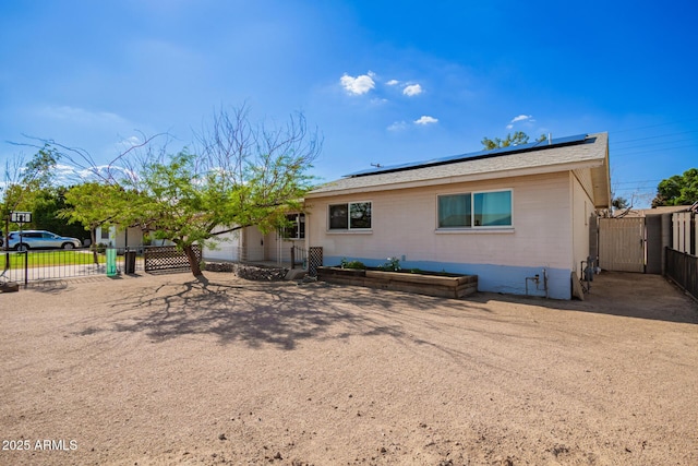 62 W Beall Ave, Mesa, AZ 85210 - view of front of property with roof mounted solar panels and a gate