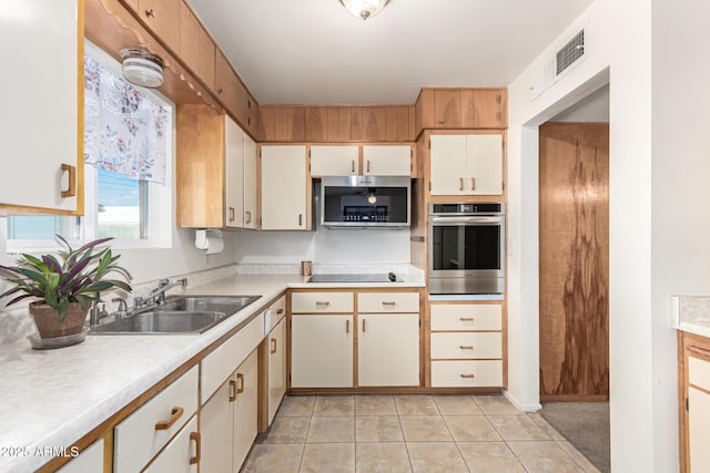 62 W Beall Ave, Mesa, AZ 85210 - kitchen with appliances with stainless steel finishes, a sink, light countertops, and light tile patterned flooring